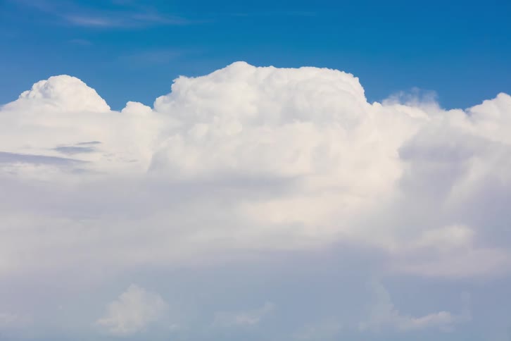 Time lapse of white clouds rolling against a blue sky