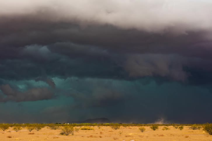A time lapse of a storm forming over a field