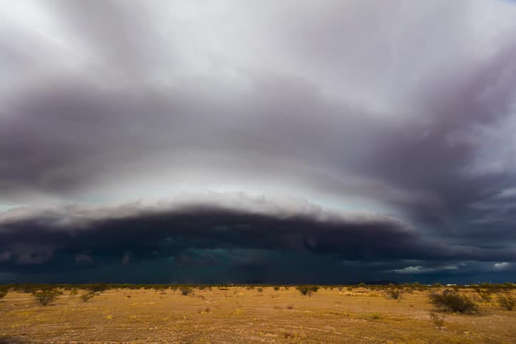 A view of a storm forming over a field