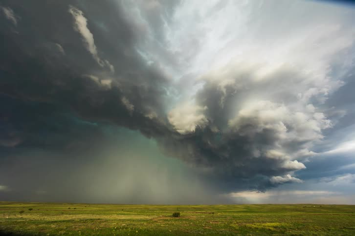 A time lapse of a storm forming over a field