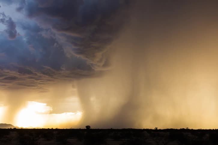 A time lapse of a storm rolling over a field