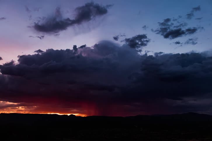 Dark clouds develop into lightning storm as night falls