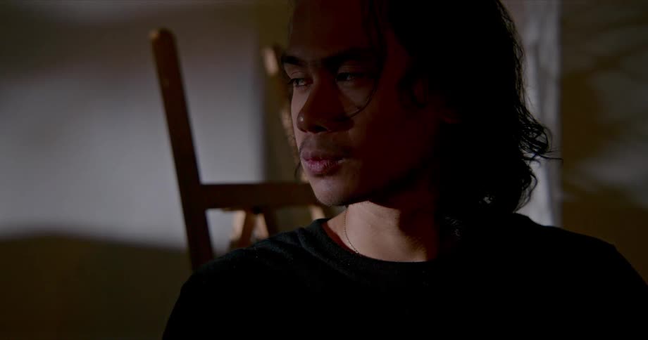 Man looks toward opening letting in light to dispel shadows