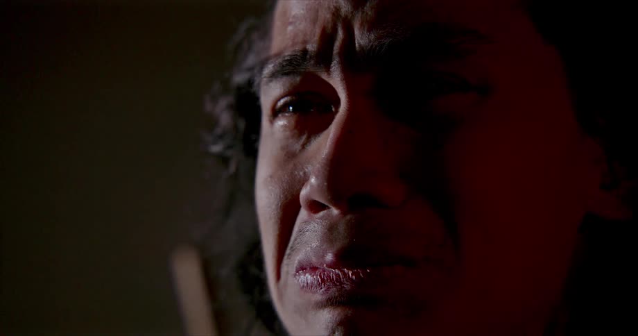 A man is crying in the dark room