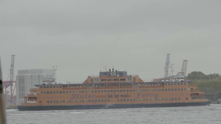 The staten island ferry travels along the water