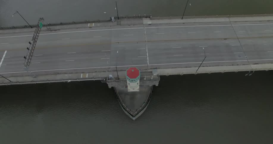 Aerial view of cars driving on a bridge and a large body of water