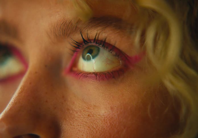 A womans face with makeup around her eyes
