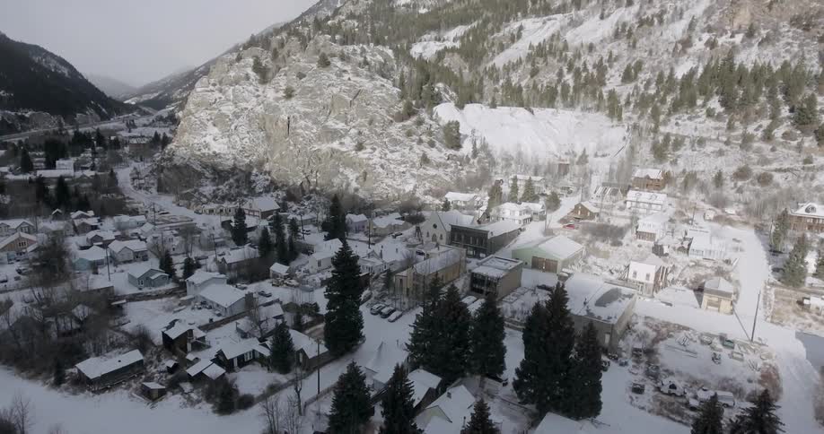 A village covered in snow sitting in a mountain valley