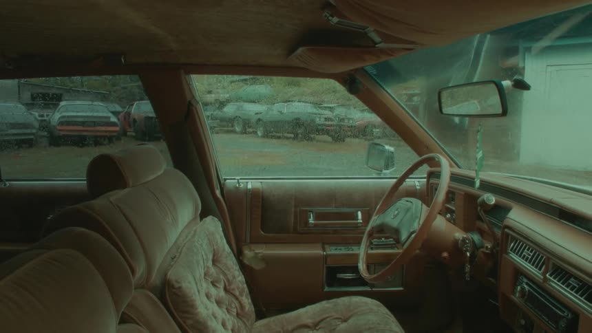 A vehicle with a steering wheel and a rearview mirror