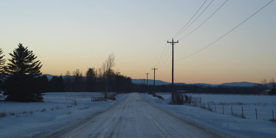 The sun is setting on the long icy road
