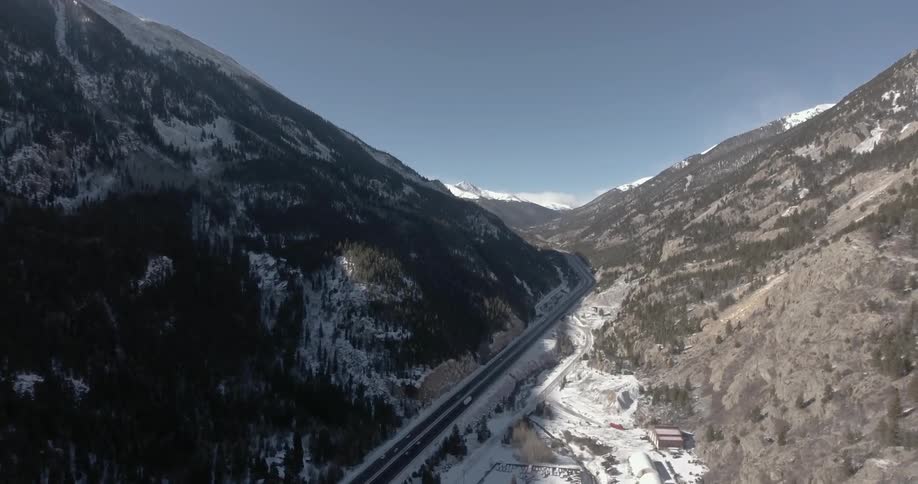 Aerial view of a small road between two mountains