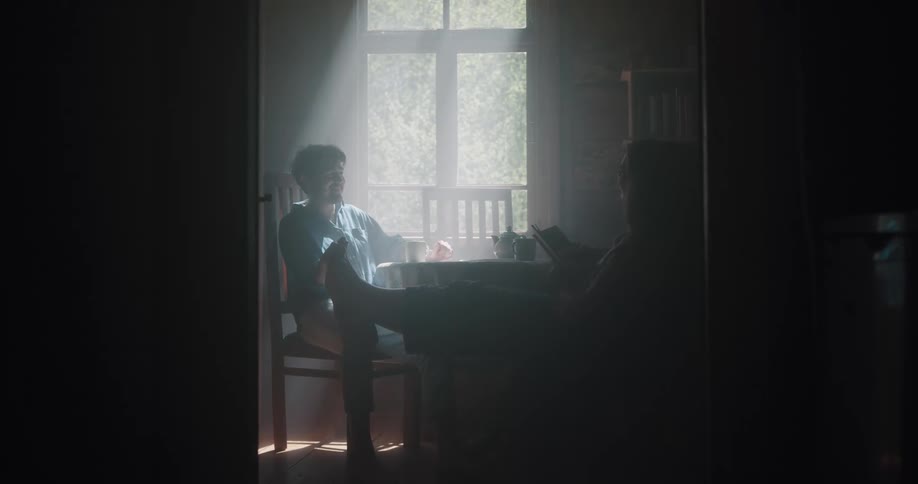 A man and woman sitting around a room together