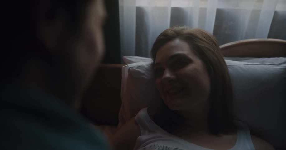 A man kisses a woman on the forehead
