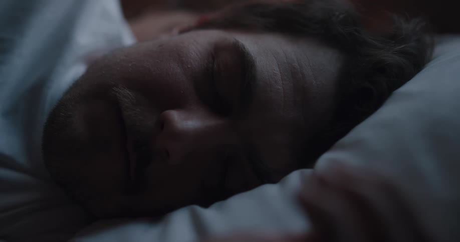 A man sleeping in a bed