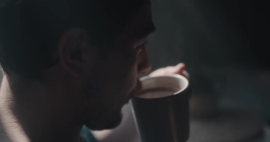 Man drinking a cup of hot coffee at home in the morning