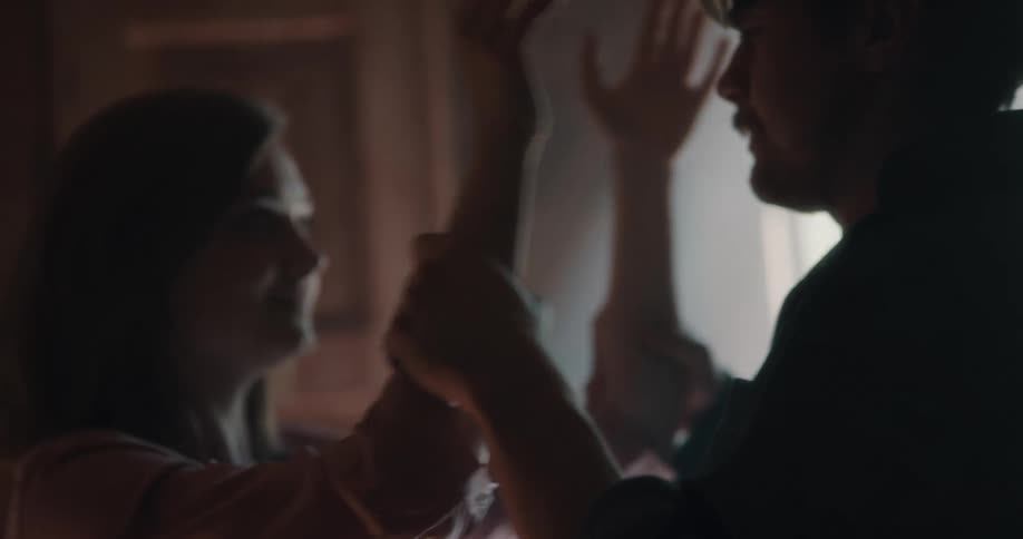 A man and woman turn towards each other and lovingly embrace