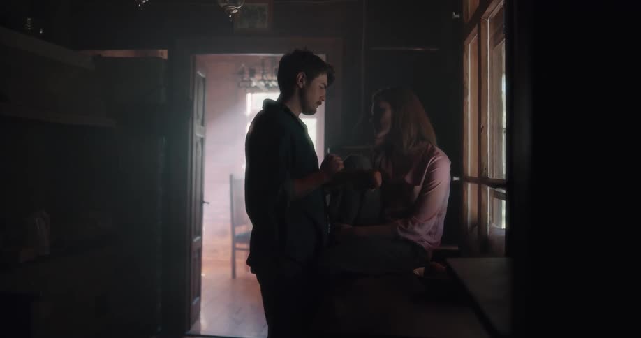 A man and woman hug at home