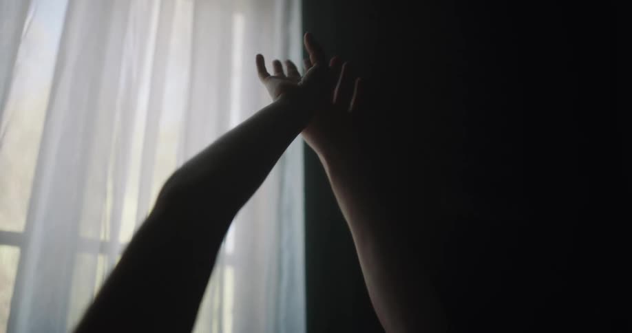 A person is stretching their arms up
