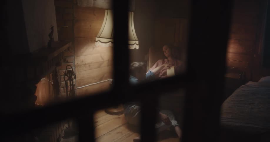 A man and woman sit together indoors in a cozy home