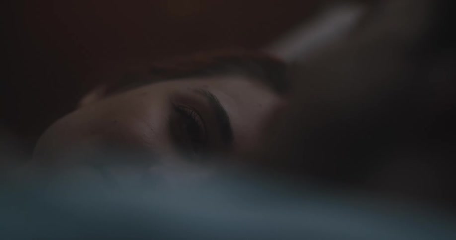 A woman is laying in her bed