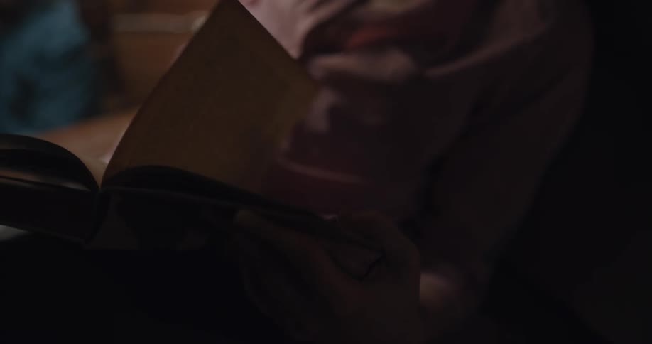 A woman is flipping through a book