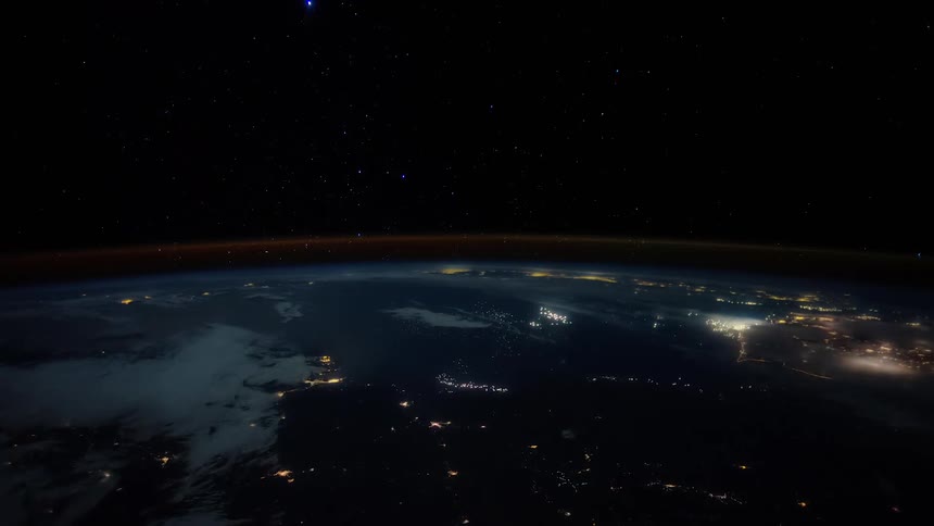 City lights glow and twinkle from outer space