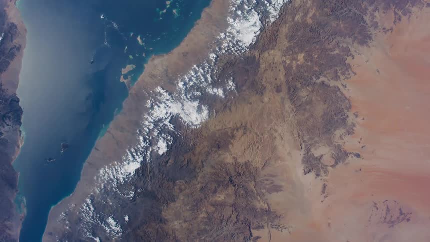 Wide blue river on a desert seen from space