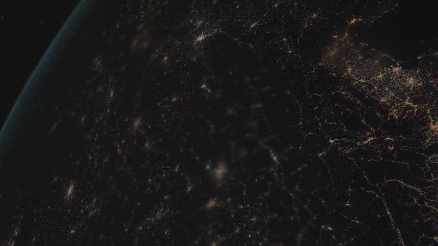 City lights shine and glow brightly on the surface of earth from space