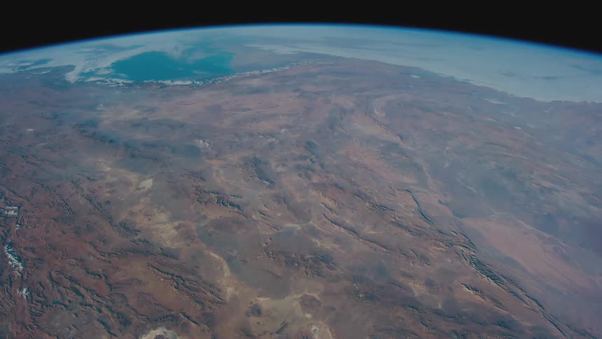 Oceans and land terrain are visible on the curved surface of earth in space