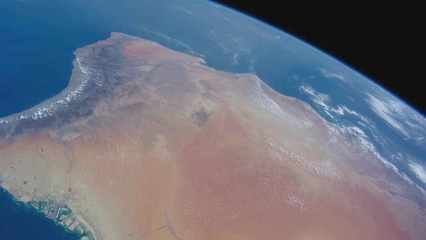 Bright blue oceans and land formation on the curved surface of earth in space