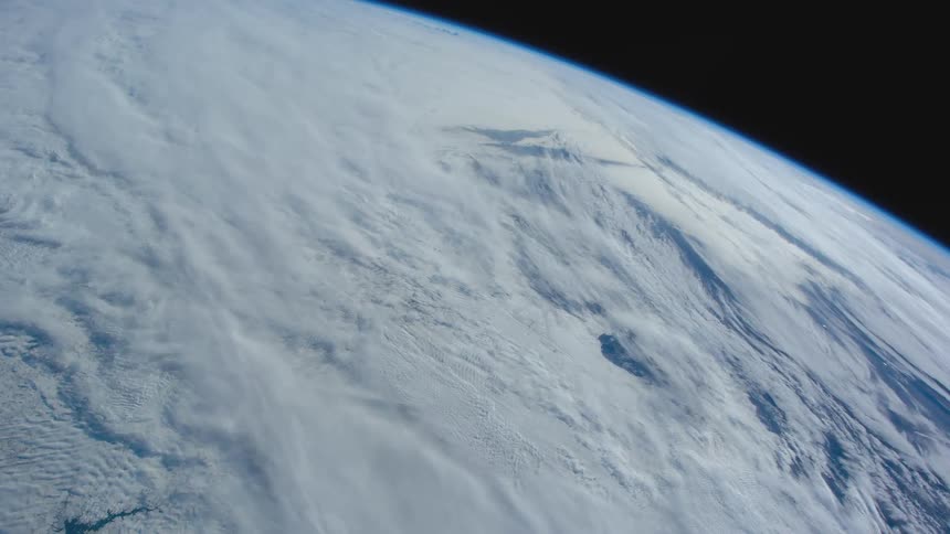 White clouds snow and ice cover hemisphere against black of space