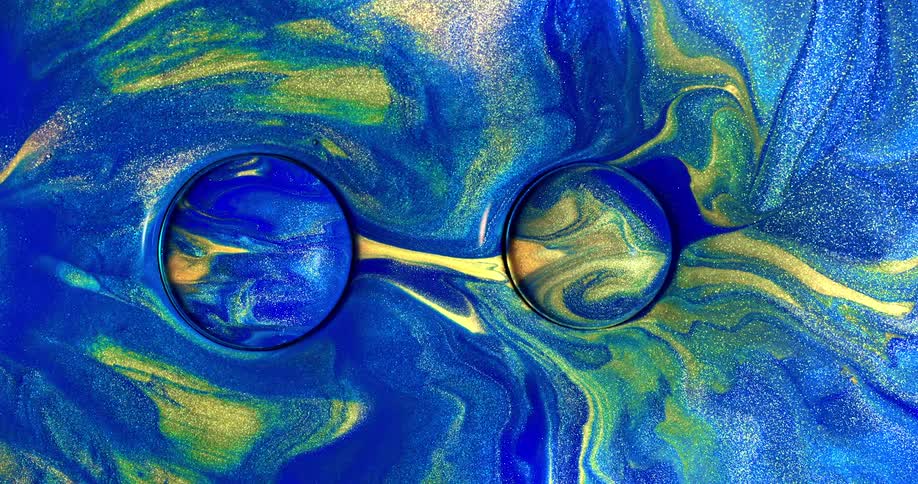 Blue and yellow paint swirling together around orbs