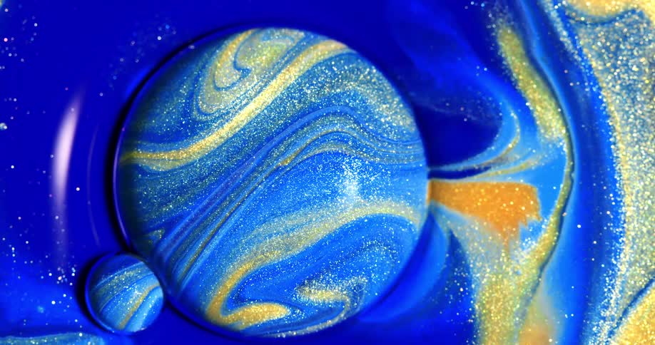 Blue and yellow glittery liquid flows over and around a sphere shape
