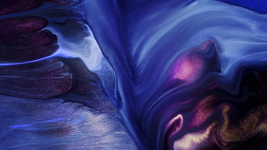 A glittery fluid with swirls of blue and purple slowly flows and mixes together