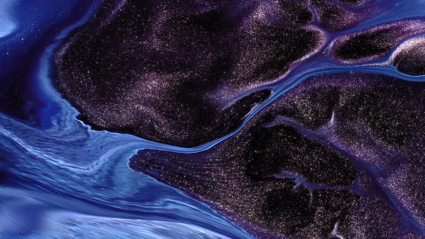 A close up footage of a purple and blue liquid mix