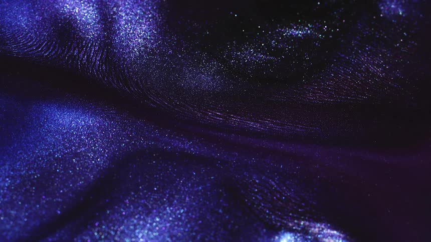 A shimmering grainy blue liquid slowly moving