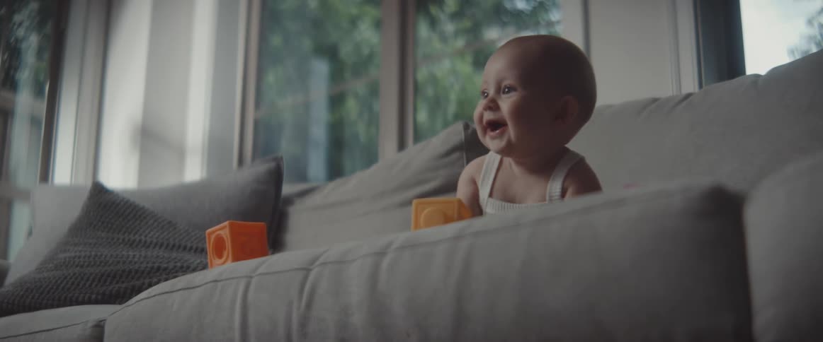 A mother and daughter playing on a couch