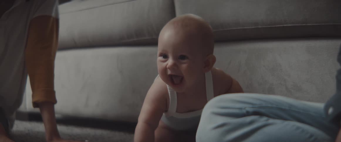 A mother and baby in a room playing