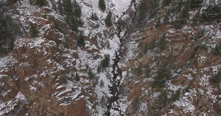 A snow covered rocky mountain valley