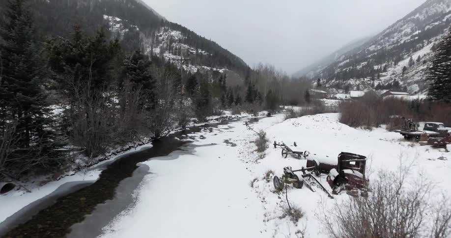 Moving fast over a snow covered field by a creek
