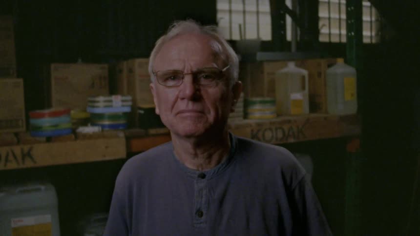 A man is posing in the warehouse