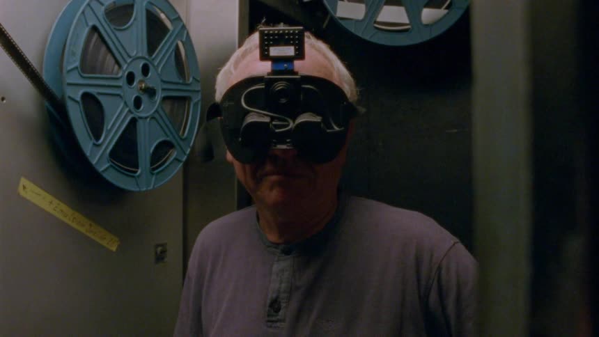A man is wearing a headset by the machine