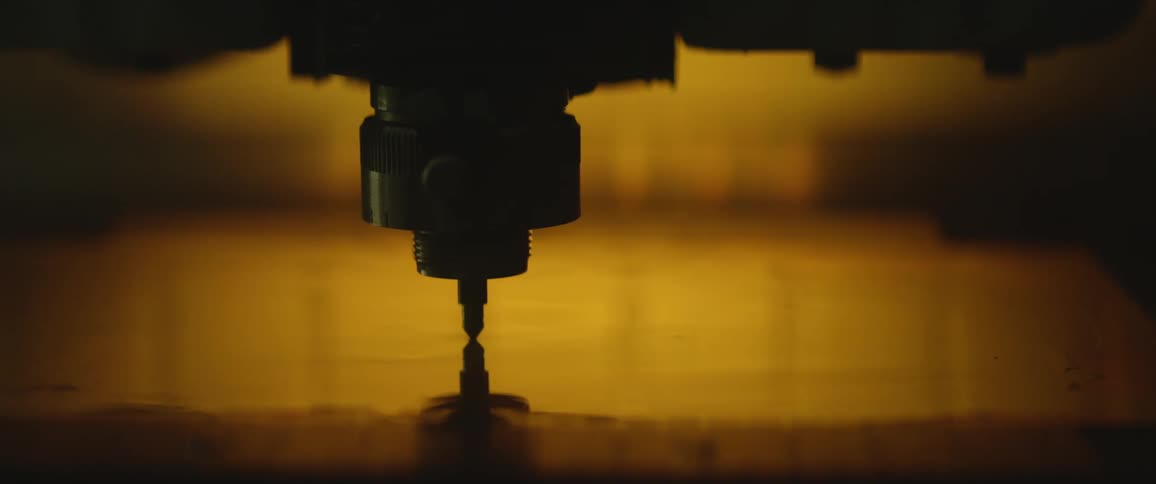 A drill bit pushing in to material as it drills