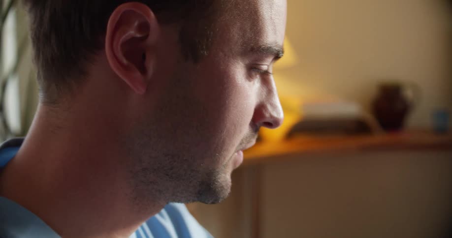 Young man working from home talking on a video call on a laptop