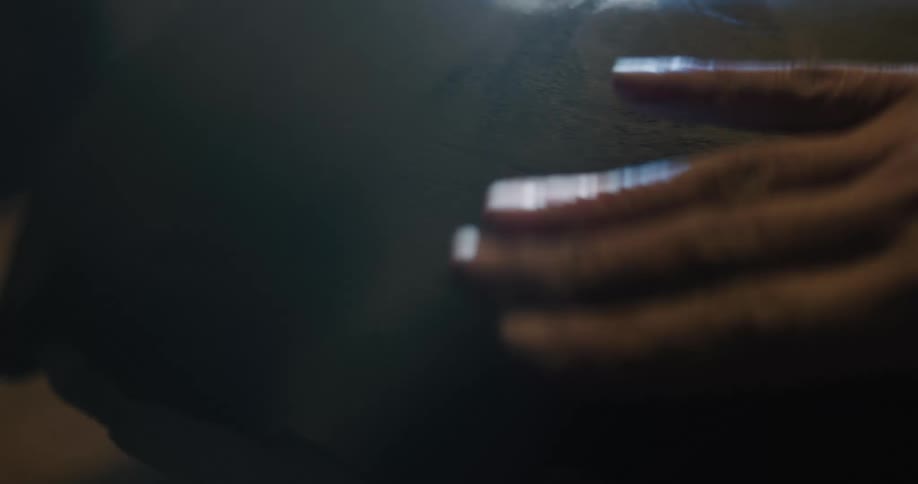A person in a room shaping a piece of clay