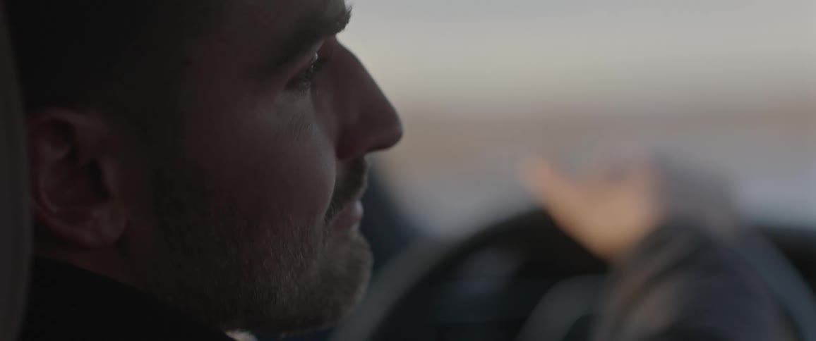 Man driving a car on the desert countryside at morning