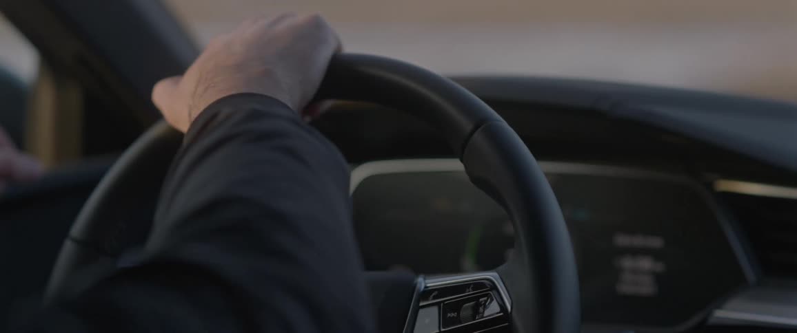 Mans hand turns the car steering wheel