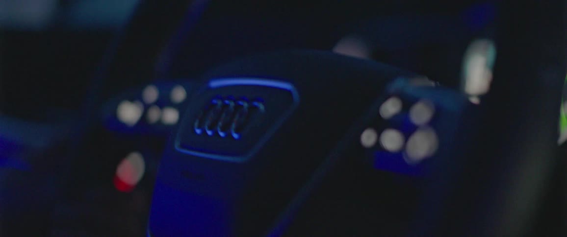 Mans hands holds steering wheel to control the direction that the vehicle goes in