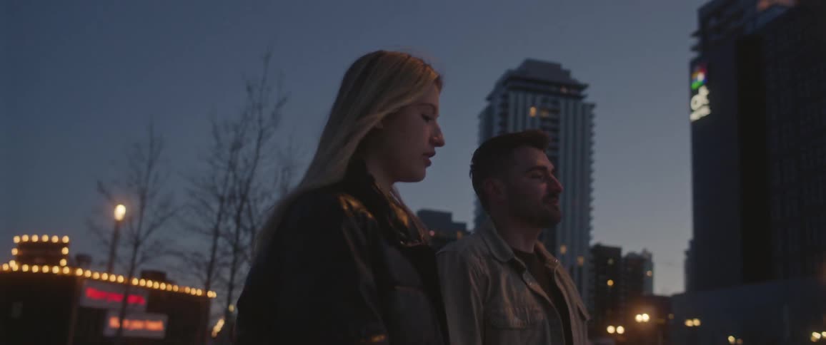 A man and woman walk in the city