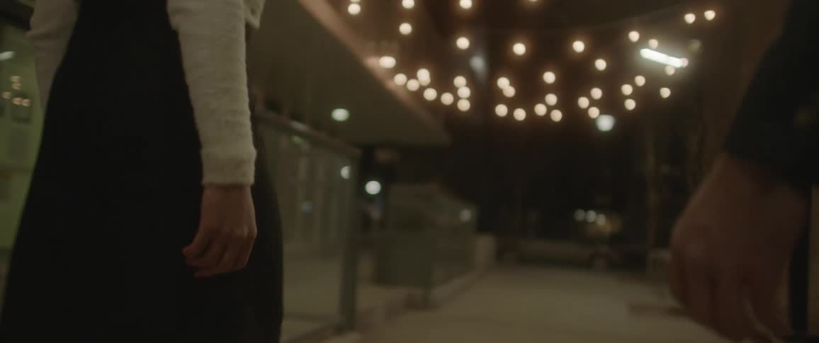 Husband and wife are holding hands and walking through a building together
